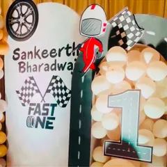 Another angle of the "Fast One" birthday theme, showing the custom arch with the number '1' and racer graphic. The details make this setup a perfect photo opportunity for the birthday boy and his guests.