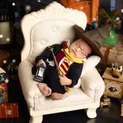 A little wizard resting after a long day at Hogwarts. I use detailed props and lighting to create a truly immersive and magical scene for your baby's themed portrait.