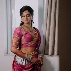 A close-up shot showing the intricate embroidery on the blouse and the beautiful drape of the Langa Dhawani.