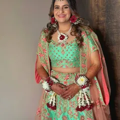 The full Haldi look, showcasing the beautiful floral jewelry and a makeup style that is both festive and natural.