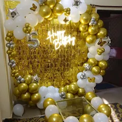 A classic and elegant theme for a 5th birthday using a gold and white color palette. This circular balloon arch with a neon sign and a number '5' foil balloon creates a stunning centerpiece for the celebration.