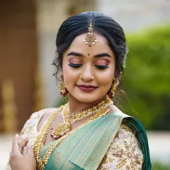 A classic South Indian bridal look with soft, shimmery eyes and traditional gold jewelry. This is a timeless look that is always in demand.