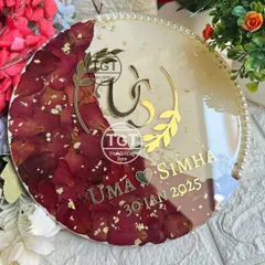 An angled view of the round plaque, highlighting the glossy finish and the elegant pearl border.