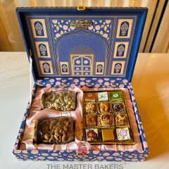 Our royal blue festive box is a statement of elegance perfect for corporate gifting. Inside, a satin lining holds jars of premium dry fruits and a selection of our finest assorted sweets, including baklava and chocolates.