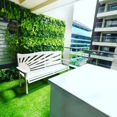 We transformed this compact city balcony into a private green oasis. The design features a full-coverage vertical garden that turns a bare wall into a living feature, complemented by low-maintenance artificial turf and a comfortable seating area, proving no space is too small for a natural escape.
