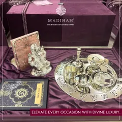Elevate every occasion with divine luxury. My Pooja Auspicious Hamper includes a silver-plated thali set, a Ganesha idol, and a Geeta Saar, all presented in a beautiful velvet box.