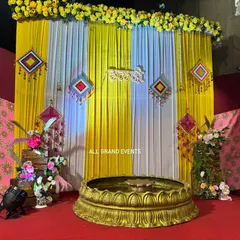 A perfect backdrop for a vibrant Haldi ceremony. We used bright yellow and white drapes, accented with traditional Rajasthani hangings and a 'हळदी' sign in Marathi script. The setup is completed with a large brass urli at the center, ready for the rituals.