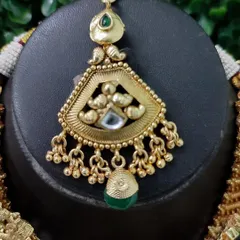 The maang tikka from this set, designed to perfectly complement the necklace.