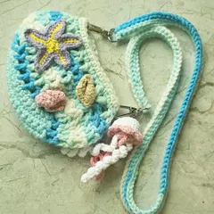 Here is the mini version of my popular Ocean Bag, perfect for a little one or for when you just need to carry the essentials. It has all the same handmade details, like the starfish and jellyfish charm, just in a smaller size.