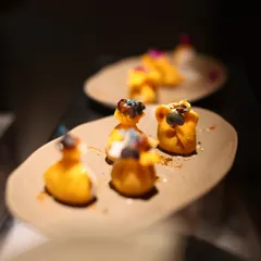 These delicately crafted dumplings are an example of the artistry we bring to our appetizers. Each piece is a bite-sized explosion of flavor, meticulously prepared and garnished for a beautiful presentation.