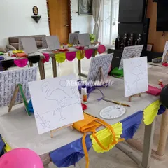 A colorful and inviting setup for a flamingo canvas painting party. We make sure every station is ready with a pre-sketched canvas, paints, and brushes.