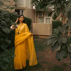 Another perspective of the outdoor saree shoot, capturing a candid moment as the subject adjusts her hair. I aim to blend posed and unposed shots for a complete narrative.