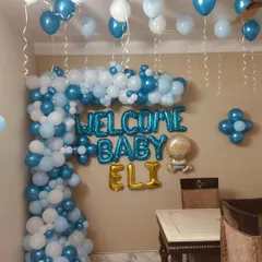 Here is a closer look at the personalized foil balloons used to welcome baby Eli. The combination of blue "Welcome Baby" letters and golden name balloons creates a beautiful focal point for the decoration.