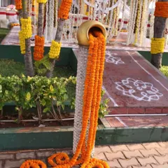 This is a popular decorative piece where marigold strings appear to flow out of a golden matka. It's a great way to add a traditional and eye-catching element to the event decor.
