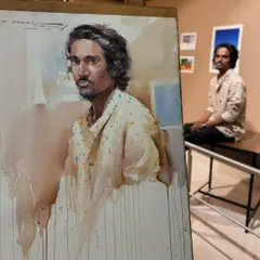 A live portrait demonstration at the Kalangan Art Exhibition in Balgandharva, Pune. The model is seated in the background, showing the setup for a live sitting.