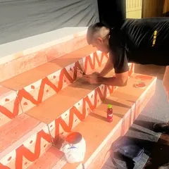 An artist carefully painting the details on our stage set. We believe every detail matters in creating a magical experience.