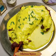 My Mutton Raan, presented in a pool of golden Peshawari sauce. The tandoori-cooked leg of mutton is generously covered in this creamy, aromatic gravy, making it a perfect centerpiece for a special occasion like an Iftar feast.