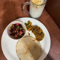 This is my idea of a wholesome Indian meal. It features a jowar roti, a side of vegetable curry, a fresh beetroot salad, and a glass of buttermilk (chaas), providing a perfect balance of carbs, protein, and fiber.