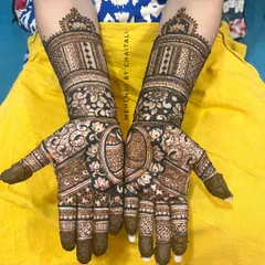 A traditional sider mehendi design that covers the full hands. It features a mix of floral, paisley, and geometric patterns, perfect for wedding guests who want an intricate look.