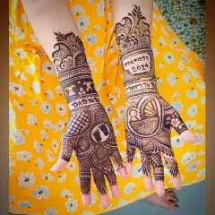 Another angle of the personalized baby shower mehandi, showing how the different elements like the cradle, footprints, and text come together across both hands.