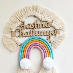 I love making these personalized rainbow name hangings for kids' rooms. This one for Aashna and Chaitanya uses soft pastel threads and fluffy pom-pom clouds to create a cheerful and dreamy piece of wall decor. We can customize the name and colors to perfectly match your little one's space.