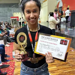 A champion's smile. Priyanka proudly displays her trophy and certificate after a dominating performance. We celebrate every victory, big and small, as a family.
