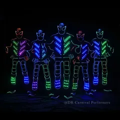 Our full Tron squad assembled and ready to perform. The vibrant colors of their suits stand out against the darkness, promising an electric show.