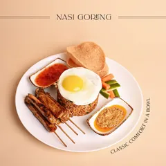 A beautifully plated Nasi Goreng, influenced by Chinese immigrants in Indonesia. The sweet and savory profile comes from kecap manis, served with chicken satay and a sunny-side-up egg.