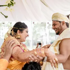 A playful moment during the wedding rituals. Capturing these candid smiles and happy interactions is what makes a wedding so memorable.