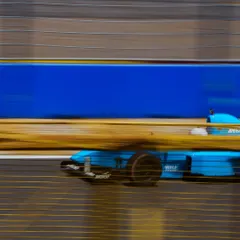 A high-speed panning shot of the F1600 car, capturing the incredible velocity of a formula race car.