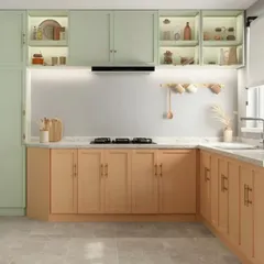 A charming pastel-themed modular kitchen with mint green upper cabinets and peach-toned lower cabinets. The in-cabinet lighting creates a lovely display effect, while the white marble countertop keeps the space bright.