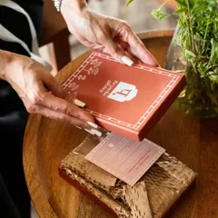 The simple act of unboxing a thoughtful gift. This lifestyle product shot for Patrika Gift Shop captures that intimate moment, showing how a product lives and breathes in the hands of the person it's meant for.