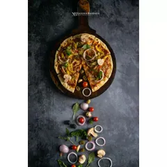 A rustic vegetable pizza, styled with its fresh ingredients cascading down the frame. This creative flatlay for Double Tree by Hilton tells the story of the pizza from ingredients to finished product.