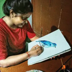 Happiness is a quiet moment with my brushes and paints. Here I am, working on a watercolor painting, a photo my mom lovingly captured.