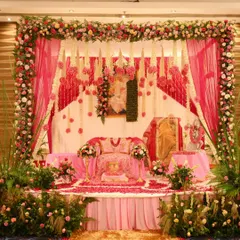 A beautiful and serene flower decoration for a Guruji Satsang. The stage is elaborately decorated with fresh flowers, creating a divine atmosphere for the spiritual gathering.