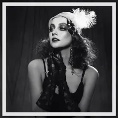 A vintage-inspired shoot channeling the glamour of the 1920s Great Gatsby era. The styling includes a feathered headpiece, dark makeup, and lace gloves to create an authentic, period-specific editorial look.