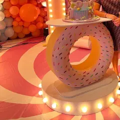 A close-up of our donut-themed LED cake table, available for rent. It's a unique and eye-catching piece that elevates any dessert or candy-themed party.