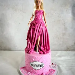 All dolled up and ready for the party! This Barbie cake features a stunning, entirely edible gown with intricate draping and texture, all made from fondant.