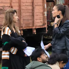 On the 'CRAKK' set, deep in conversation about costume details. Clear communication with the actors and director is essential to my process.