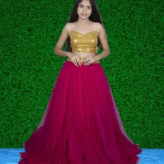 A modern lehenga set featuring a gold sequin top paired with a bright pink tulle skirt. This is a great outfit for sangeet or mehendi functions.