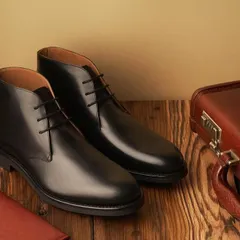 A classic still life for Hanker Boots. The black leather chukka boots are paired with a vintage-style briefcase, telling a story of travel, business, and timeless style.
