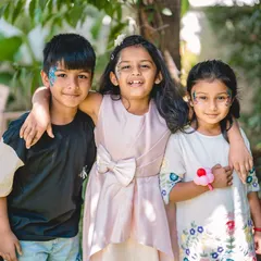 The joy of friendship and celebration. This candid shot of children at a birthday party, complete with face paint and smiles, captures the fun energy of the day.