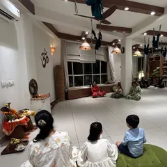 Our space is for everyone. Here, a family sits together during our Ganesh Chaturthi pooja, sharing a moment of devotion. We believe in celebrating our traditions together, creating memories and passing on our values to the next generation.