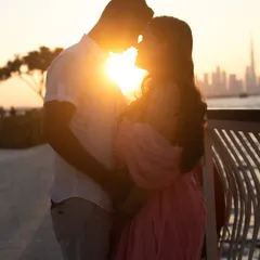 There is nothing more romantic than a silhouette against a sunset. This golden hour shot in Dubai captures the quiet, intimate connection between partners as they wait for their new arrival, with the city skyline painting a perfect backdrop.