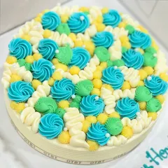 You can't go wrong with my signature buttercream cake. This one is covered in colorful swirls of blue, green, and yellow, making it bright and cheerful.