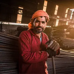 For me, photography is about finding beauty everywhere. This portrait of a worker, captured in the golden light of a factory, shows the power of authentic, environmental portraiture.