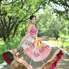 A playful and vibrant patchwork lehenga with a full flare, perfect for a twirl. The mix of pink, yellow, and green with traditional motifs makes this a standout choice for a Mehendi or Sangeet function.