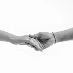 Sometimes, the simplest image is the most profound. This minimalist black and white shot of hands connecting is a beautiful, symbolic representation of a couple's bond.