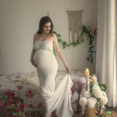 A serene and classic portrait in a simple white gown. The clean, bright look of this image against the boho backdrop of macrame and indoor plants creates a feeling of peace and purity.