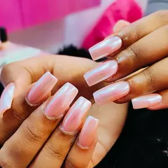 The perfect glazed donut look. These square-shaped nails have a soft, iridescent pink chrome finish that creates a beautiful, pearly shine that's both trendy and elegant.